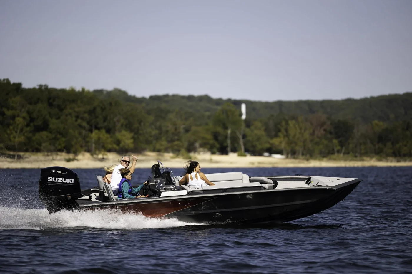 Bass boat with a Suzuki outboard running across open water