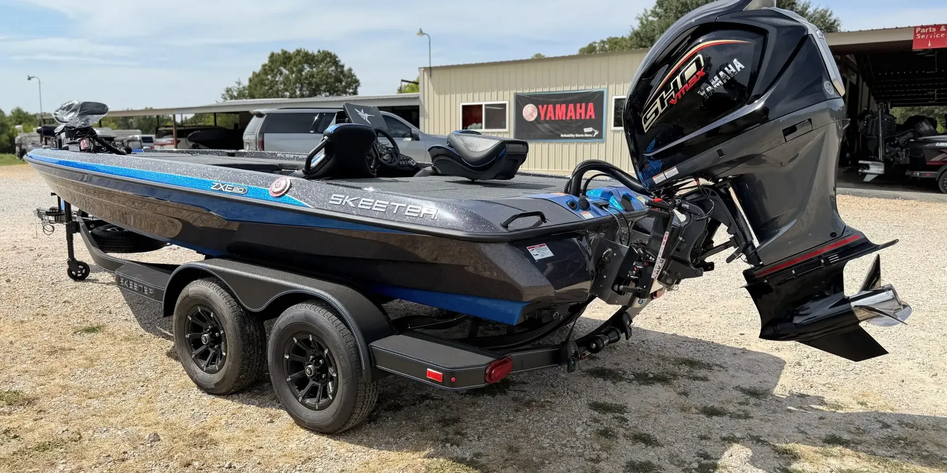 Skeeter ZXE20 bass boat with a Yamaha SHO outboard in front of the Sartin Marine shop